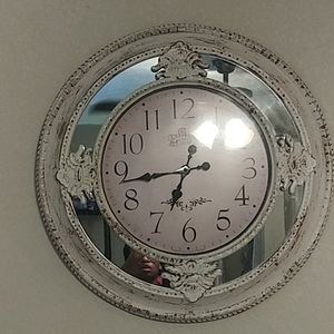 A big clock, and 2 candles with 2 candle holders